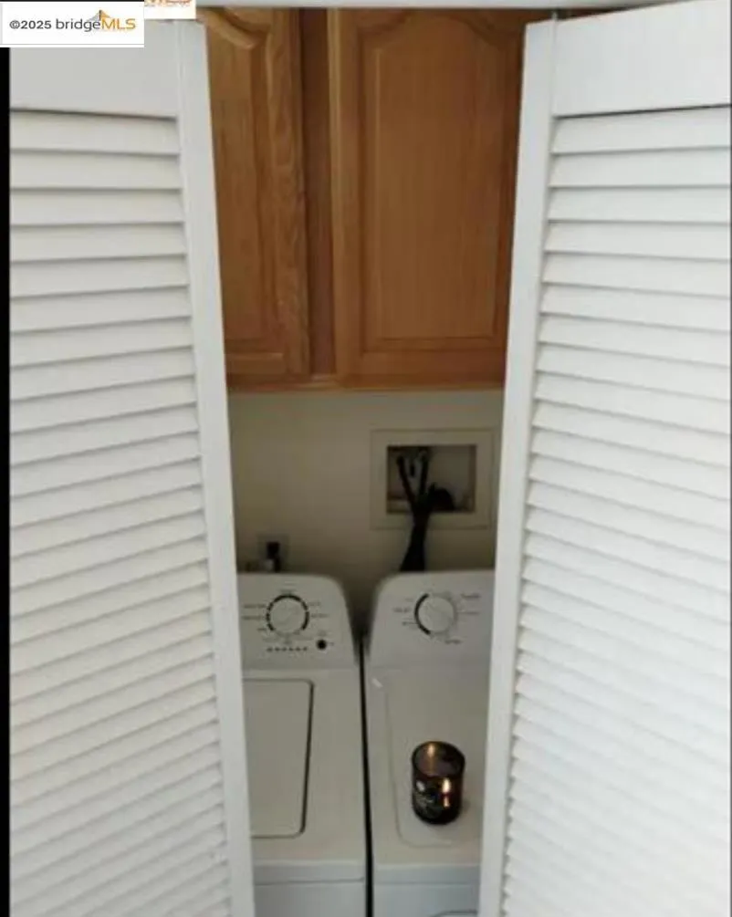 Laundry room with cabinet space and washing machine and clothes dryer