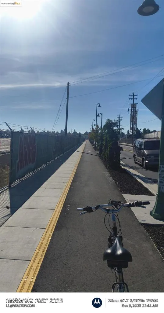 View of asphalt road with sidewalks and street lighting