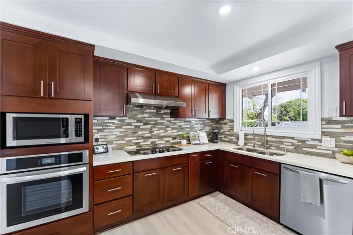 New paint and LVP flooring, neutral tones, and plenty of storage space make this kitchen easy to work in!