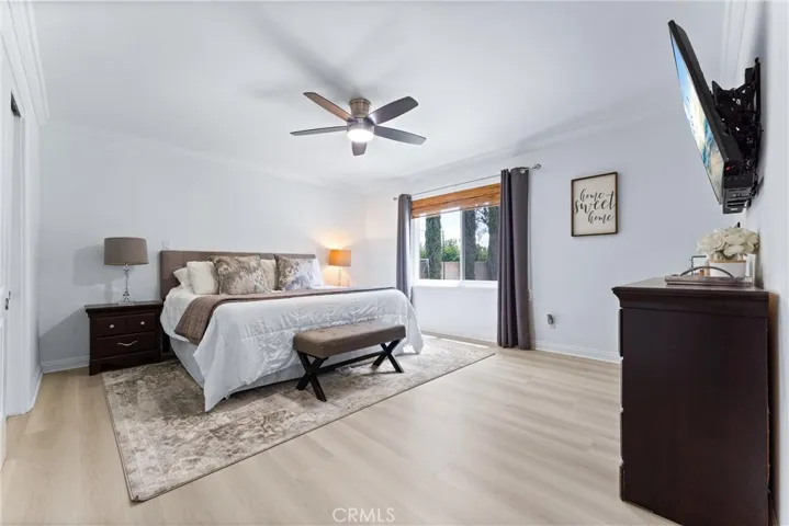 Primary Suite has new LVP flooring, paint, ceiling fan, and large window overlooking the backyard!