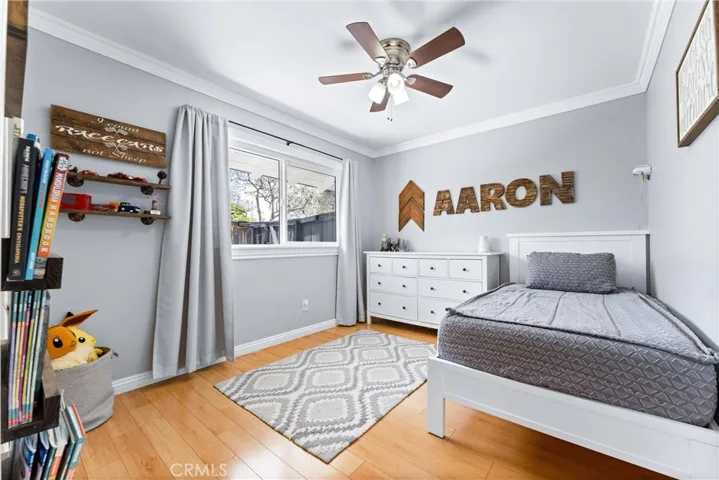 Bedroom #3 has wood flooring, ceiling fan, crown moulding, window overlooking the side yard, and walk-in closet!