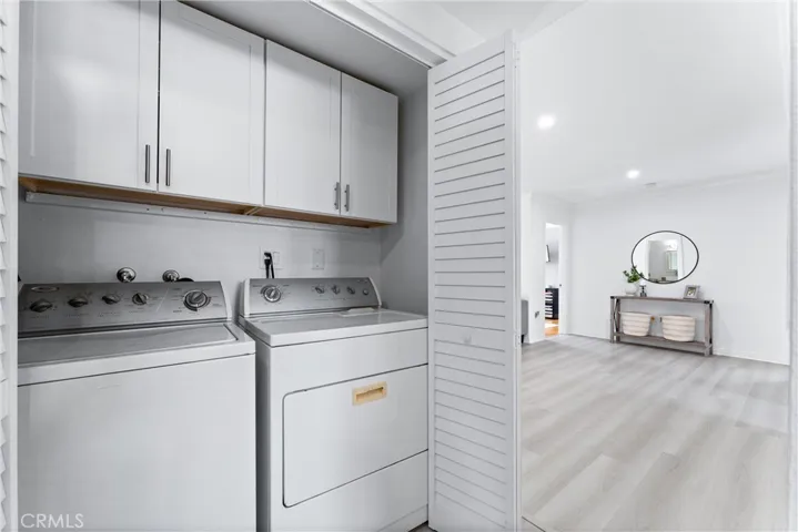 Laundry closet is located off the hallway and has plenty of built-in cabinetry!