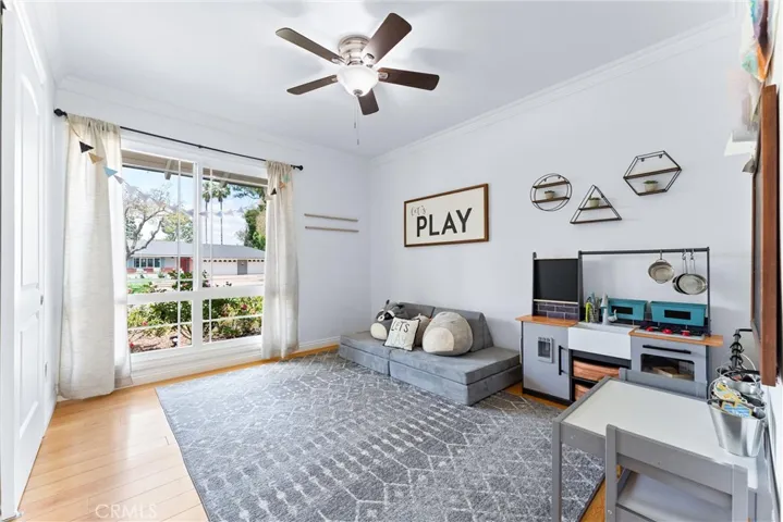 Bedroom #2 has wood flooring, ceiling fan, and large windows overlooking the front yard!