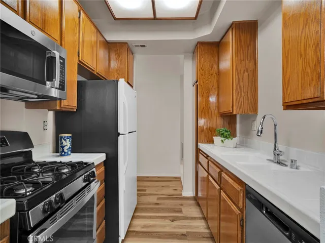 Bright and functional kitchen layout with direct access to the entry hallway