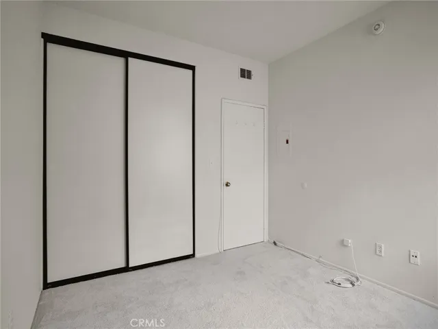 Secondary bedroom with double door, sliding closet and private entry