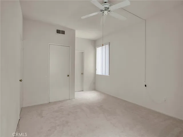 Spacious master bedroom with walk-in closet, window and direct access to the en suite bathroom