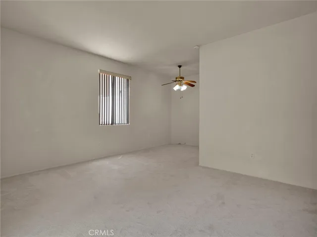 View from living room into the dining area, featuring a bright window and inviting space.