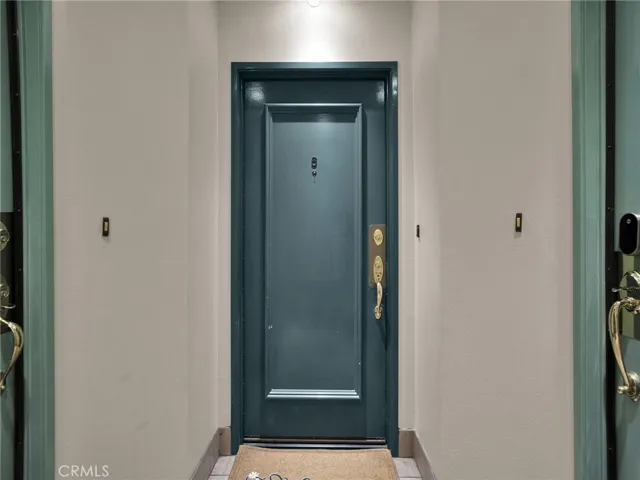 Unit #6 entrance, set beyond the hallway with a direct, welcoming walkway to the front door.