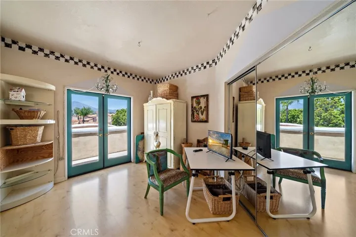Upstairs secondary bedroom with it's French doors to the private balcony with mountain views.
