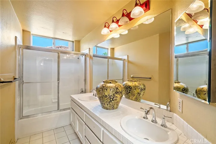 Secondary bathroom with dual sinks.