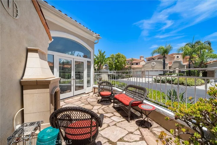 Side patio with fireplace and French doors off the sitting area by Great room.