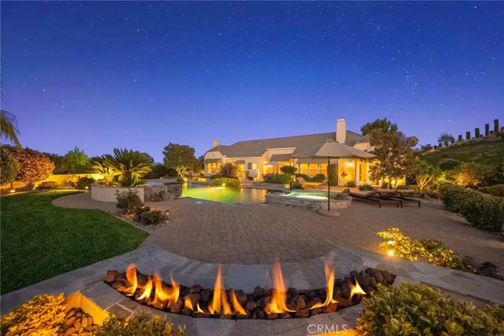 Firepit overlooking pool and main home