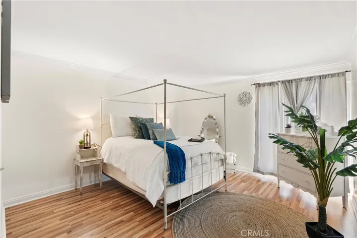 Spacious master bedroom with laminated floors