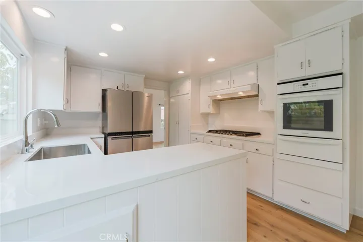 Quartz counters modernize the elegant kitchen.