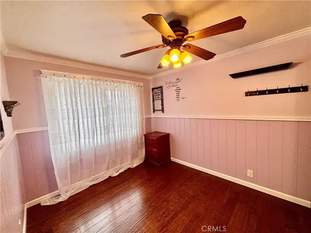 Much detail with wainscoting and ceiling fan.