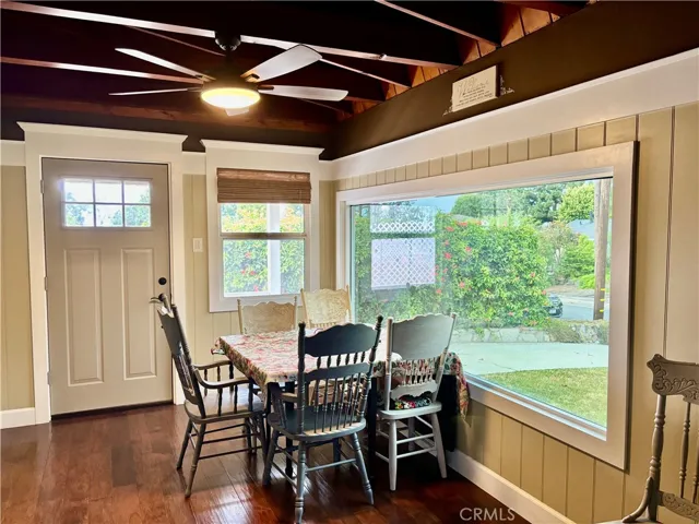 Dining room with huge windows and ceiling fan