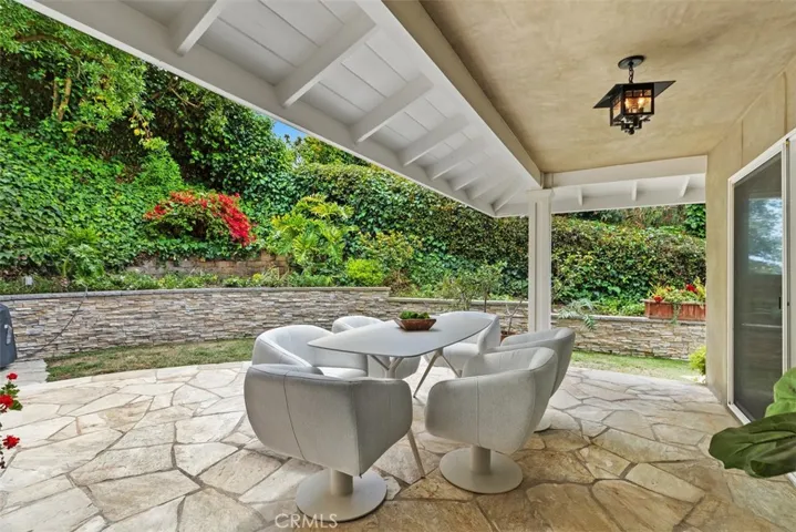 Rear patio with lush landscaping.