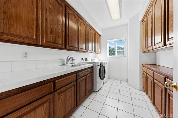 Upstairs laundry room with sink