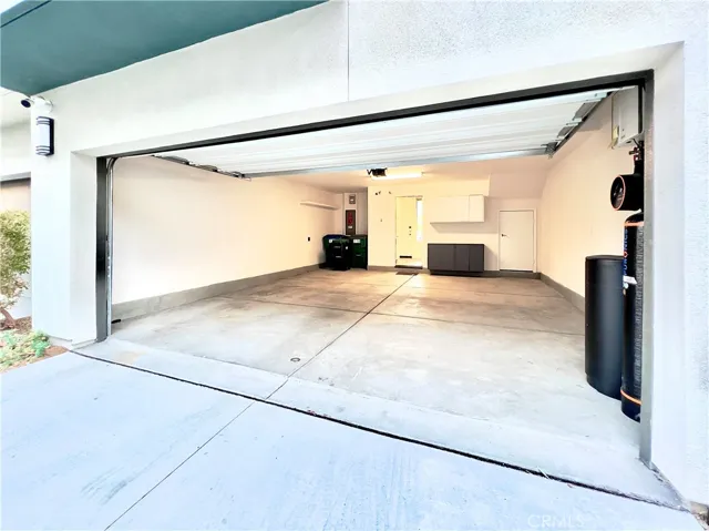 Attached two-car garage with water softening system, EV car charging, and storage area