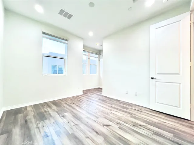 Secondary bedroom with automatic blinds, walk-in closet and separate full bath.