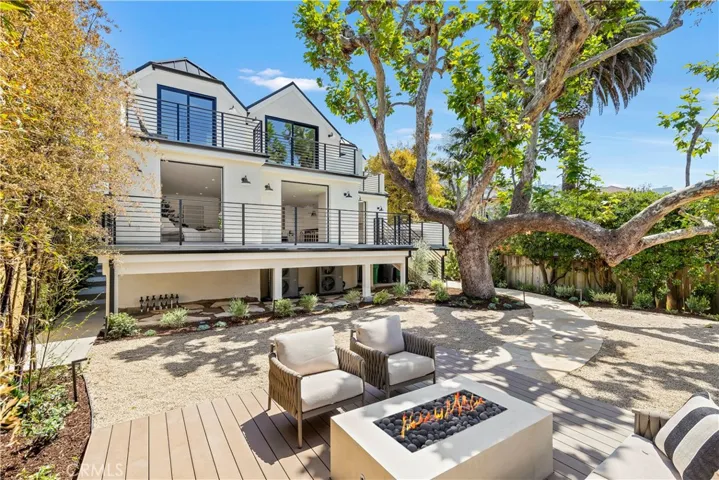ANOTHER VIEW OF REAR YARD WITH BUILT-IN FIREPIT AND GORGEOUS SYCAMORE TREE FRAMING THE ENVIRONMENT