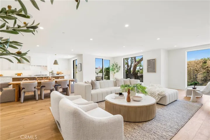 ANOTHER VIEW OF GREAT ROOM FROM LIVING AREA TOWARD DINING, KITCHEN AND DECK