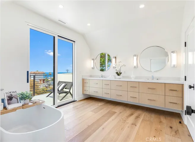 PRIMARY BATH WITH LARGE WALK IN SHOWER, FREESTANDING TUB AND FLOATING VANITY.