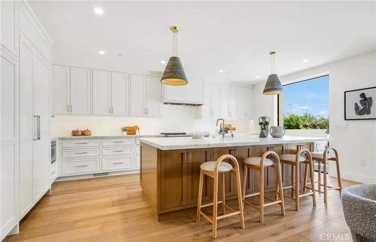 ANTOHER VIEW OF KITCHEN/ISLAND. NOTE OPEN DOORS. OCEAN BREEZES EVERYWHERE.