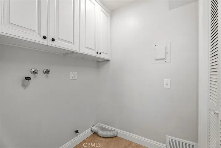 Separate laundry room sits just off the kitchen