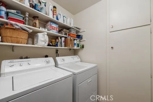 Laundry room with linen and broom closet