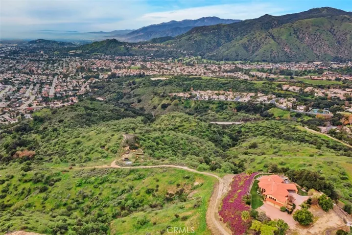 Aerial view of house and scenic hillside.