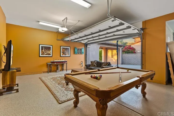 One of the double garages is currently used for a game room