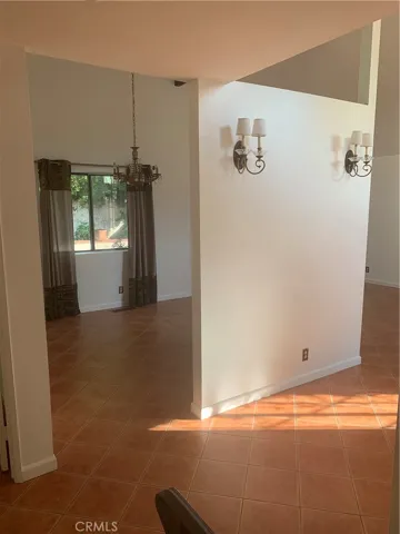 Formal dining room and entry foyer with candelabra fixtures