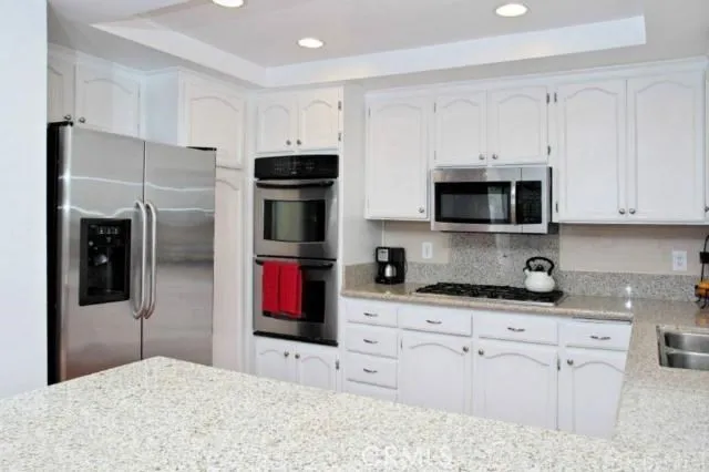 Kitchen with granite counter tops island double oven cooktop (gas) built in microwave lots and lots of cabinet space.