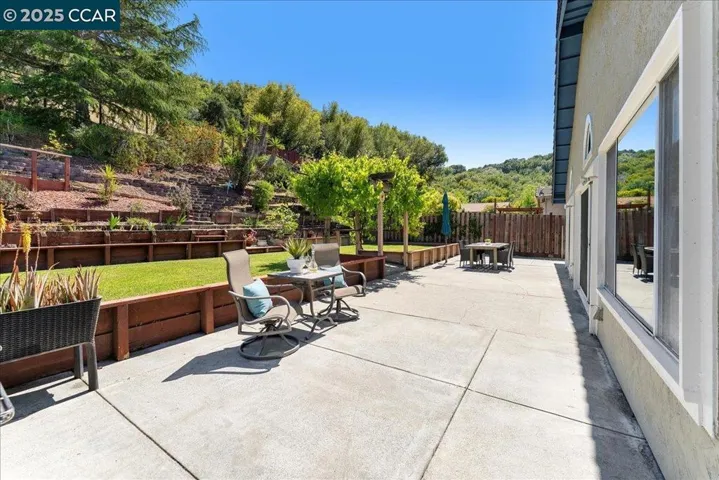 Dine al fresco under a leafy canopy of grapevines