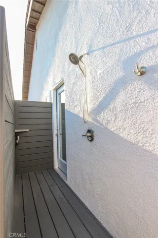 Outdoor shower with entry to primary bathroom