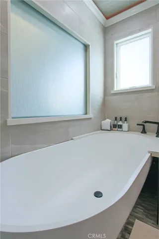 Soaking tub with "infinity" spillover drainage into shower pan