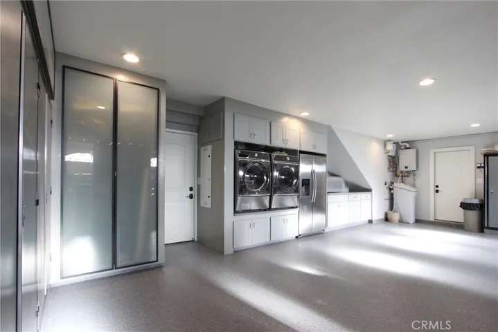 3 car garage with custom storage and laundry buildout
