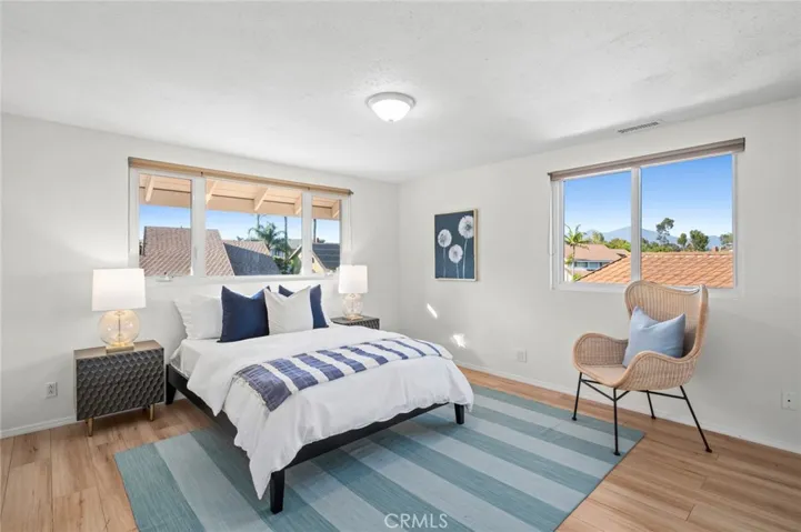 Upstairs bedroom with 2 oversized windows & updated flooring. View of Saddleback Mountain