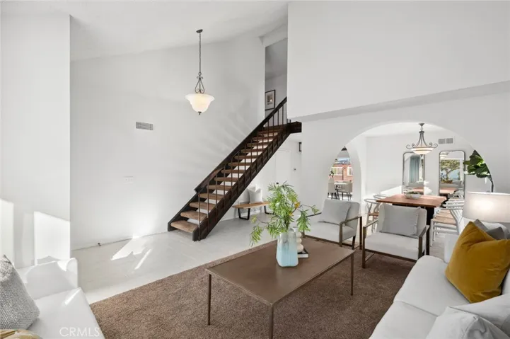 Soaring ceilings & dramatic archway set the sophisticated ambiance