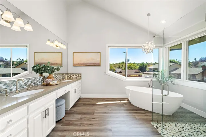Primary bathroom with double sinks, higher ceilings and natural light