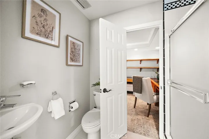 Downstairs bathroom #3 between office space and pool/activity room with shower