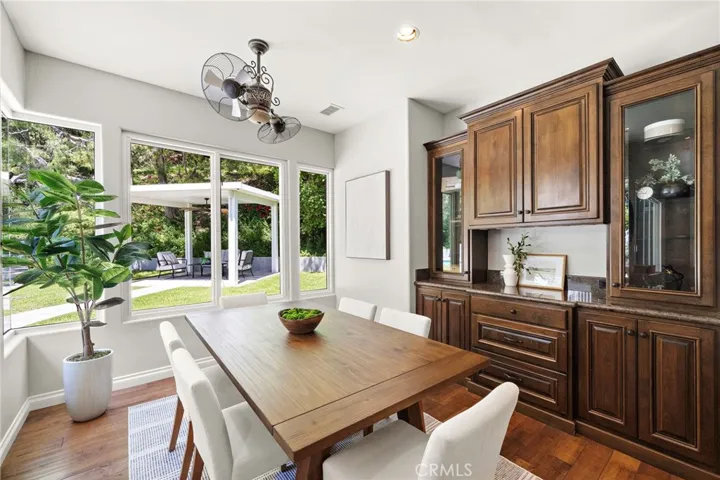 More dining in kitchen with beautiful built-ins and view to backyard oasis