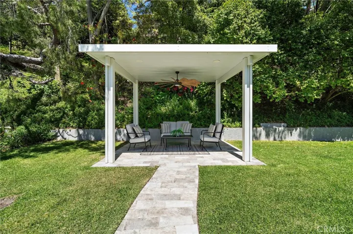 A great place to relax among the trees -- under the new pergola with tile path, flooring and ceiling fan