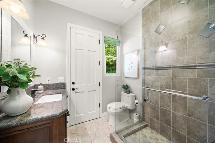 Bathroom off of kitchen and family room with door to backyard for access to pool and spa.