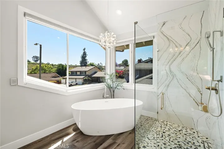 Spa-like primary bathroom with soaking tup and separate shower