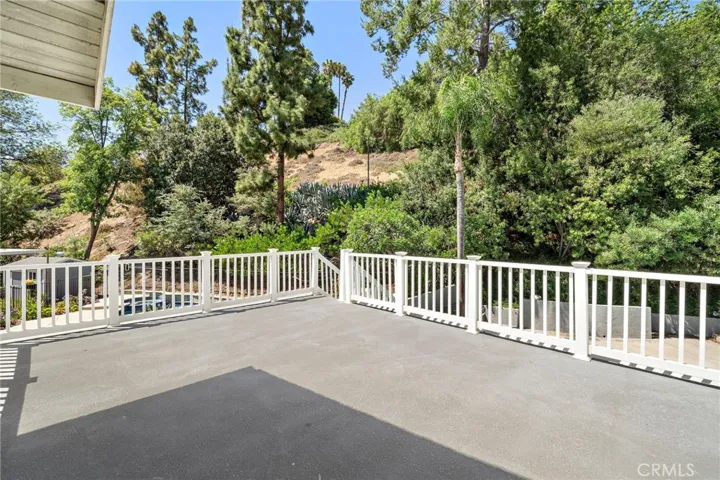 Deck off of primary suite with tree top views