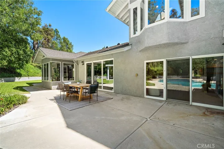 Backyard spacious patio with two slider doors for easy entertaining