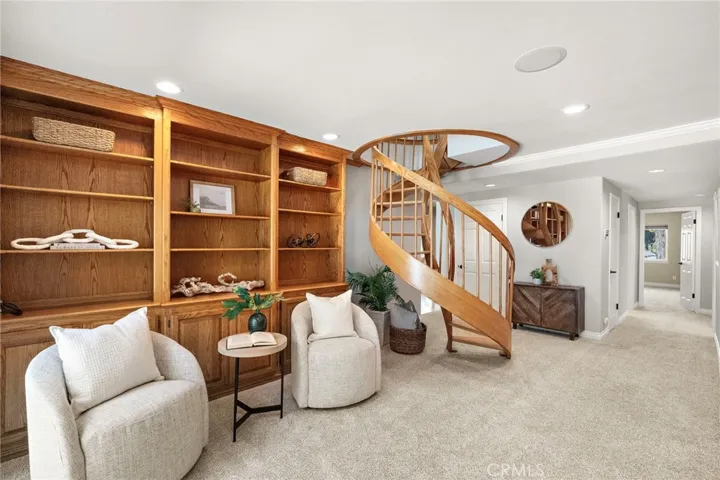 Study/office space with spiral staircase to upstairs primary retreat