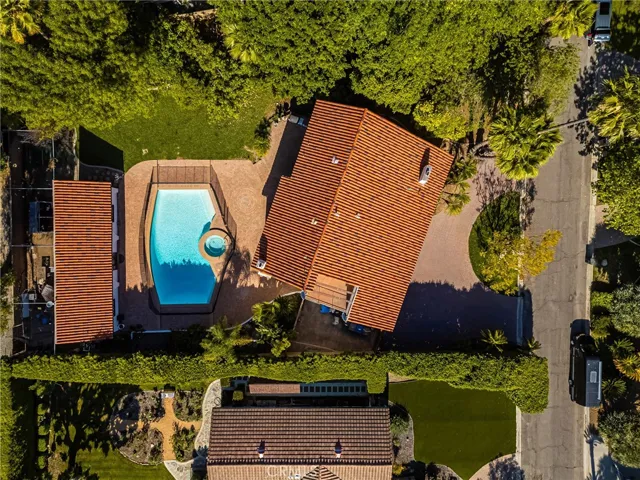 Fabulous 21,000 + square foot Lot with large back entry RV access gate to the property, just behind the Pool House.  This luxury property boasts a gorgeous sparkling pool, spa, pavered patio deck, elevated barbeque area, batting cage, mature landscaping and more.